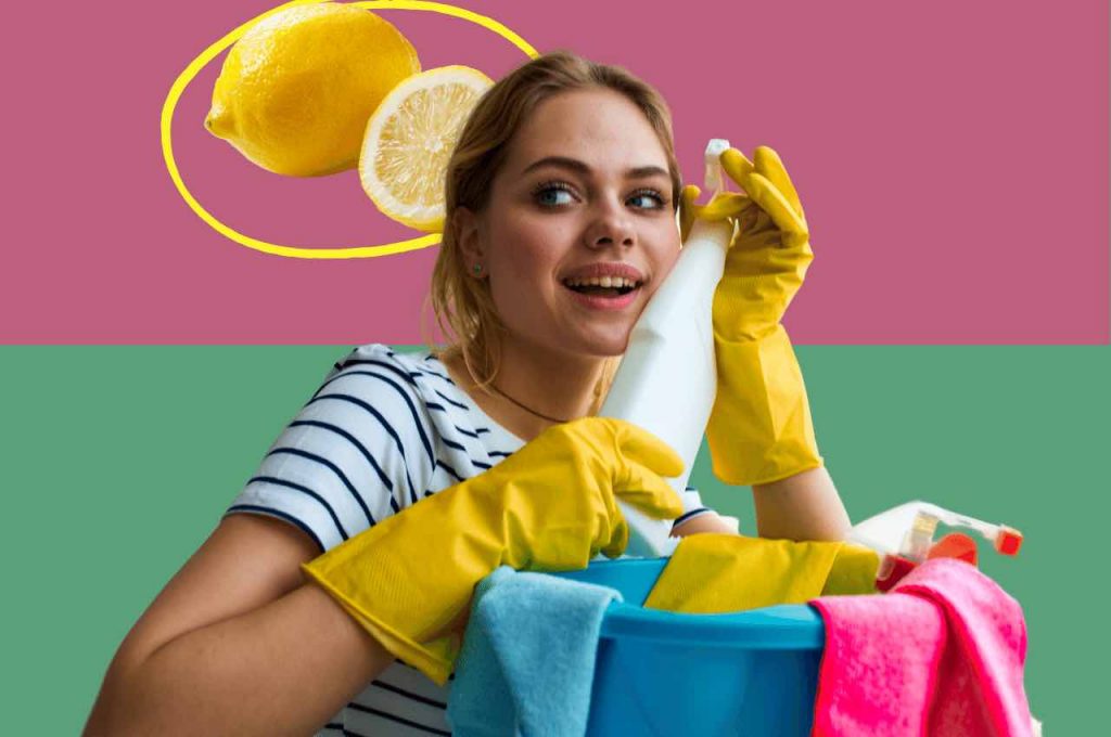Donna con prodotti per pulire, alle spalle limone e scorza